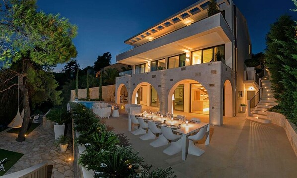 The landscaped yard of Croatian luxury holiday villa Silvery Moon on Brac for vacation and rent.
