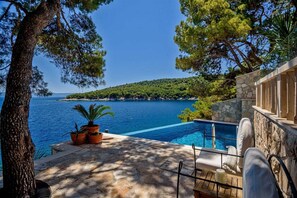 Infinity heated pool by the sea in Brač luxury villa for vacation and rent with private parking.