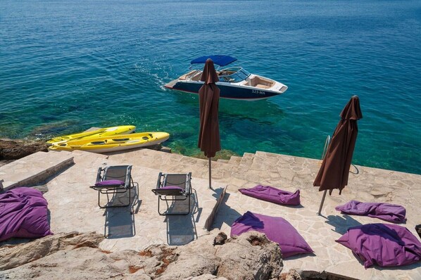 Sunbathing area around family luxury villa Brač for vacation and rent with heated pool and parking.