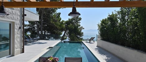 Private heated pool of the beachfront villa with concierge service on Brac island for vacation with friends