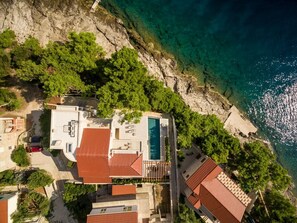 Aerial view of the Croatian luxury beachfront villa White Bellezza with private pool on Brac island for vacation with friends