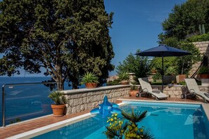 Sun loungers by the private pool of Croatia luxury seafront family villa Dubrovnik Palace