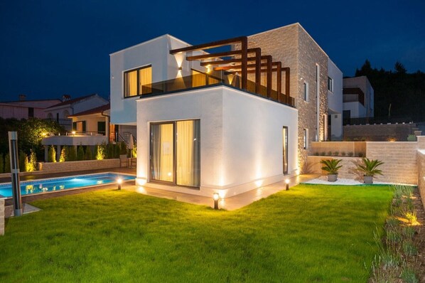 Landscaped private garden in the fenced yard of the Croatia luxury villa Trogir 1 with pool in Okrug Gornji 