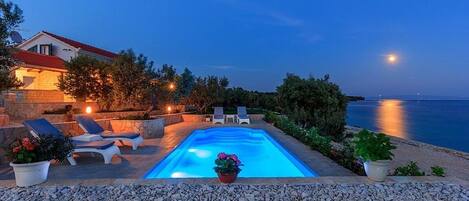 Private pool with deck chairs of the luxury vacation villa in Okrug Gornji, Ciovo with concierge service