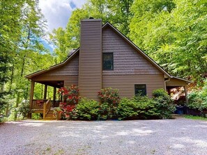 Side of house, parking area. 
