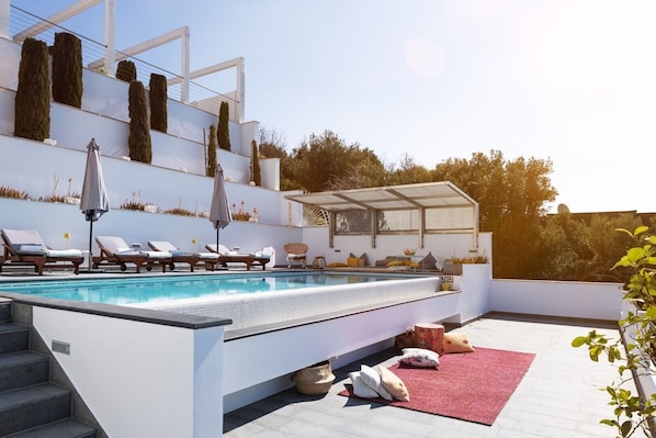 Luxury pool area with deck chairs and seating area of the modern vacation villa in Dubrovnik