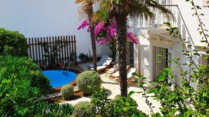 Outdoor terrace with private pool, surrounded by greenery and bushes in a holiday villa in Orebic