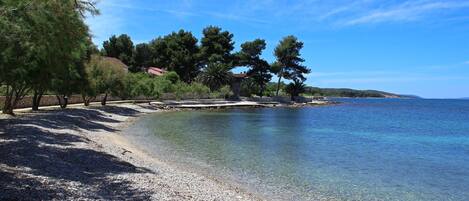 Pebble beach in front of Croatia luxury family villa Mediterranean for vacation by the sea