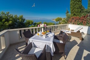 Sea view from the private terrace with sun loungers and table in front of the luxury villa Oasis in Primošten
