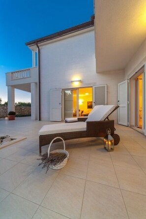 Spacious terrace with sun loungers in front of the luxury pool villa Primosten Oasis 