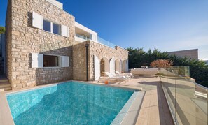 A view of the outdoor private pool surrounded by deckchairs on the outdoor terrace of the luxury private villa Primosten Glamour 