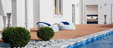 Sunbeds next to the private pool on the outdoor terrace of the Croatian luxury holiday villa Cesara in Vabriga in Istria