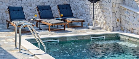 A view of the sun loungers by the pool at the Croatian luxury Dream and Live villa rental property