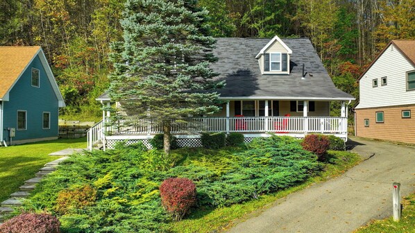 summer time view of front of house with 50' covered front porch