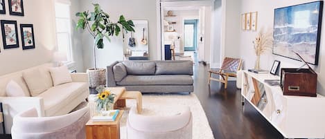 Living Room with 60" Samsung Frame TV and antique upright piano