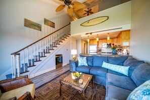 Comfortable living room with stairs to loft. Drink fridge under the stairs.