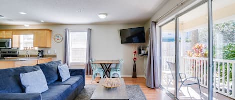 Living Room | Breathe Easy Rentals - Enjoy this cozy living room when you are done for the day with all your adventures. Plenty of room with a new sofa sleeper, flat screen tv and your 1st floor private patio.