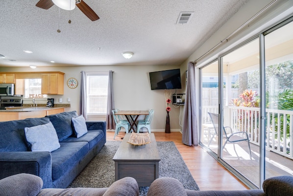 Living Room | Breathe Easy Rentals - Enjoy this cozy living room when you are done for the day with all your adventures. Plenty of room with a new sofa sleeper, flat screen tv and your 1st floor private patio.