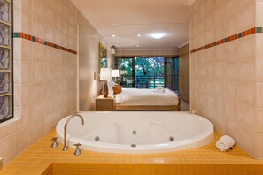Indulge in the open-plan ensuite, featuring a double vanity and a bathtub that flow seamlessly into the primary suite.
