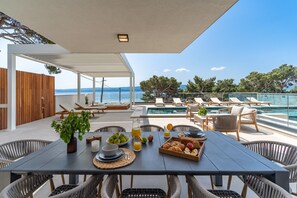 The outdoor offers a covered dining area with a barbecue