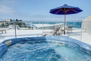Outdoor spa on upstairs balcony.