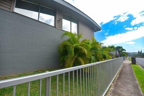 Sidewalk side of Hale Maluhia with secured fence from streetside. 