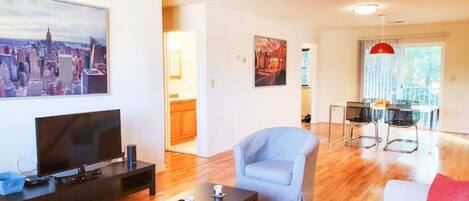 Sunny living room flows into the dining space adjoining the patio.