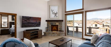 Beautiful living area with, high ceilings, gas fireplace, smart tv, and views of the Continental Divide.