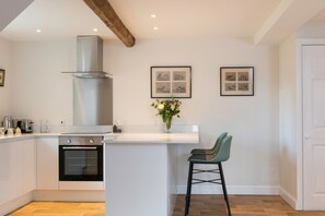 Ground floor: Open plan kitchen with breakfast bar and stools