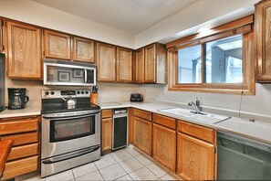 Kitchen is fully equipped and features stainless-steel appliances