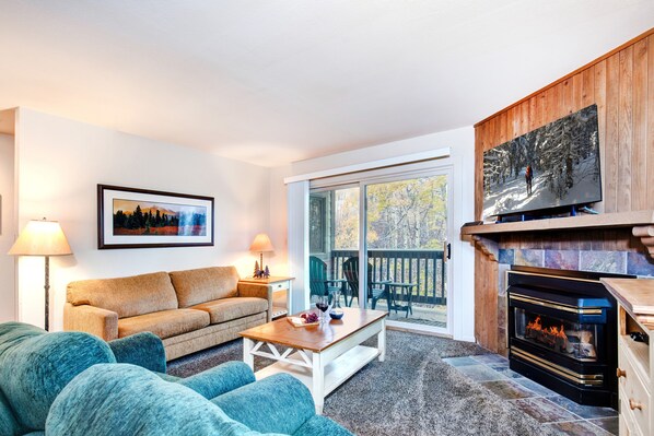 Cozy living room with gas burning fireplace and flat screen TV.