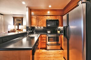 Kitchen includes solid wood cabinets and stainless steel appliances