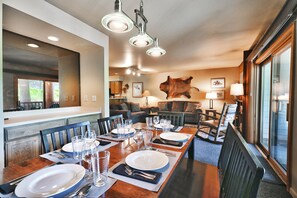 The dining area overlooks the living room and includes seating for six at the rectangle table.