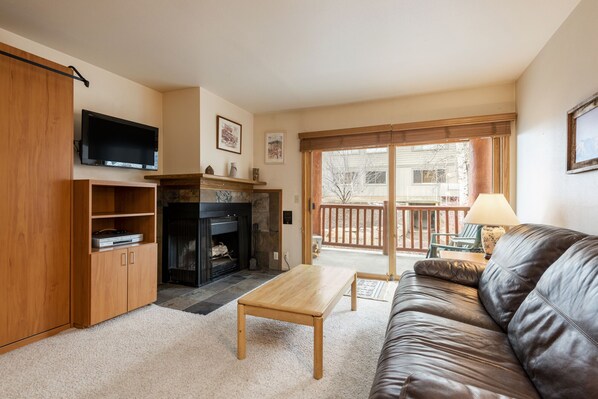 Flat screen TV and wood burning fireplace