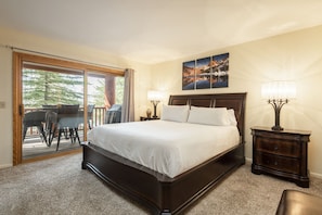 Main bedroom features a king-sized bed with access to the private patio