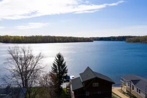 Across the lake from secluded woods.