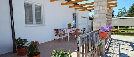 The magnificent terrace has a table and 4 chairs, awnings, gate and railing