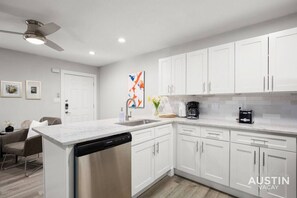 Fully stocked kitchen with dishwasher and washer & dryer