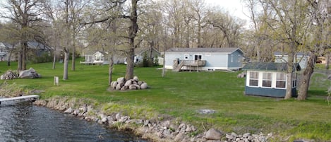 Water view of cabin, bahrzebo, and yard 
