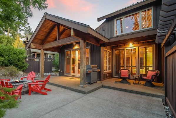 Twilight ambiance sets the mood on this covered patio with cozy lounge chairs