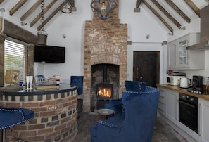 Ground floor: Open-plan living space with a unique focal point, a 40-foot well with a glass top features as the dining table
