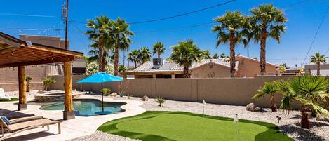 Closed in backyard with pool and entertainment.