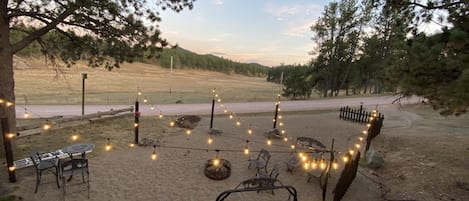 Firepit and seating area looking over the meadow 