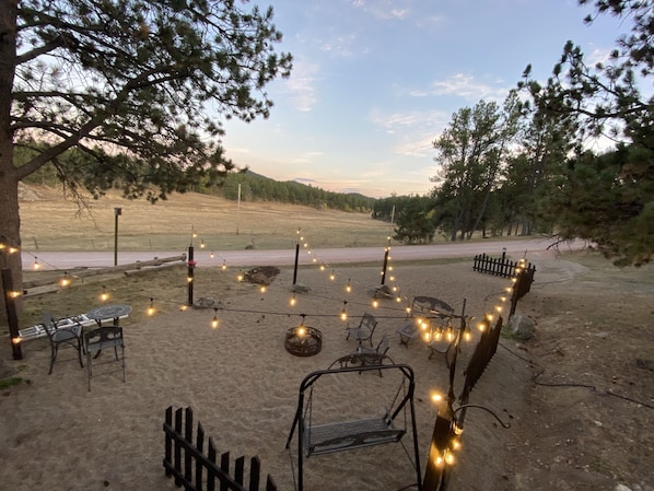 Firepit and seating area looking over the meadow 