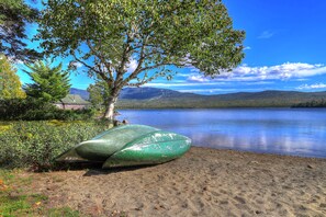Shared waterfront beach with canoes