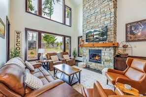 Cozy up to the Floor-to-Ceiling Stone Gas Fireplace in Our Mountain Home Living Room