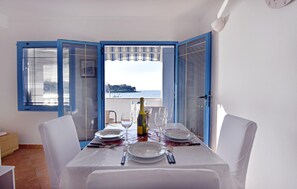 The living area with dining table and sea view