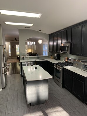 Modern kitchen with all appliances, counter top convection oven & coffee station