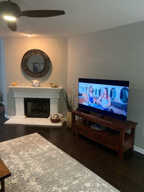 Living space has gas burning fireplace and 65" Smart TV with free YouTube. 