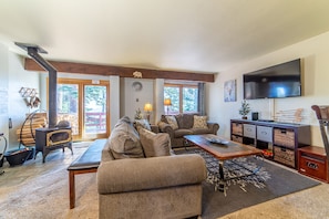 Open living area with wood burning fireplace.